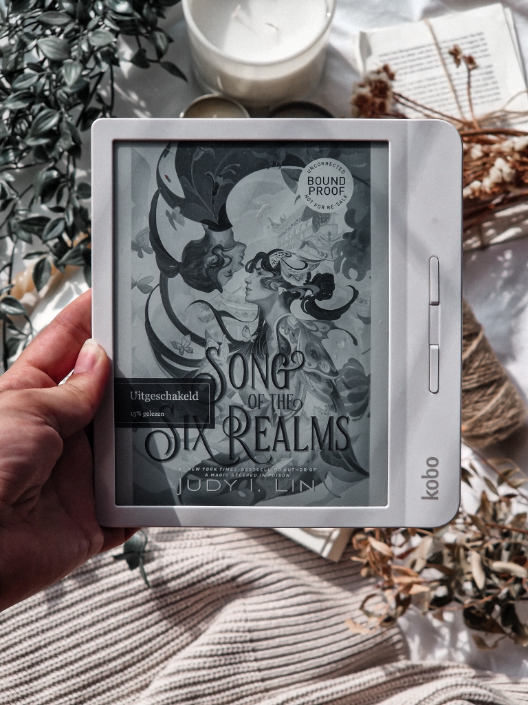 Kobo Libra E-reader with the cover of 'Song of the Six Realms' on it by Judy I. Lin.