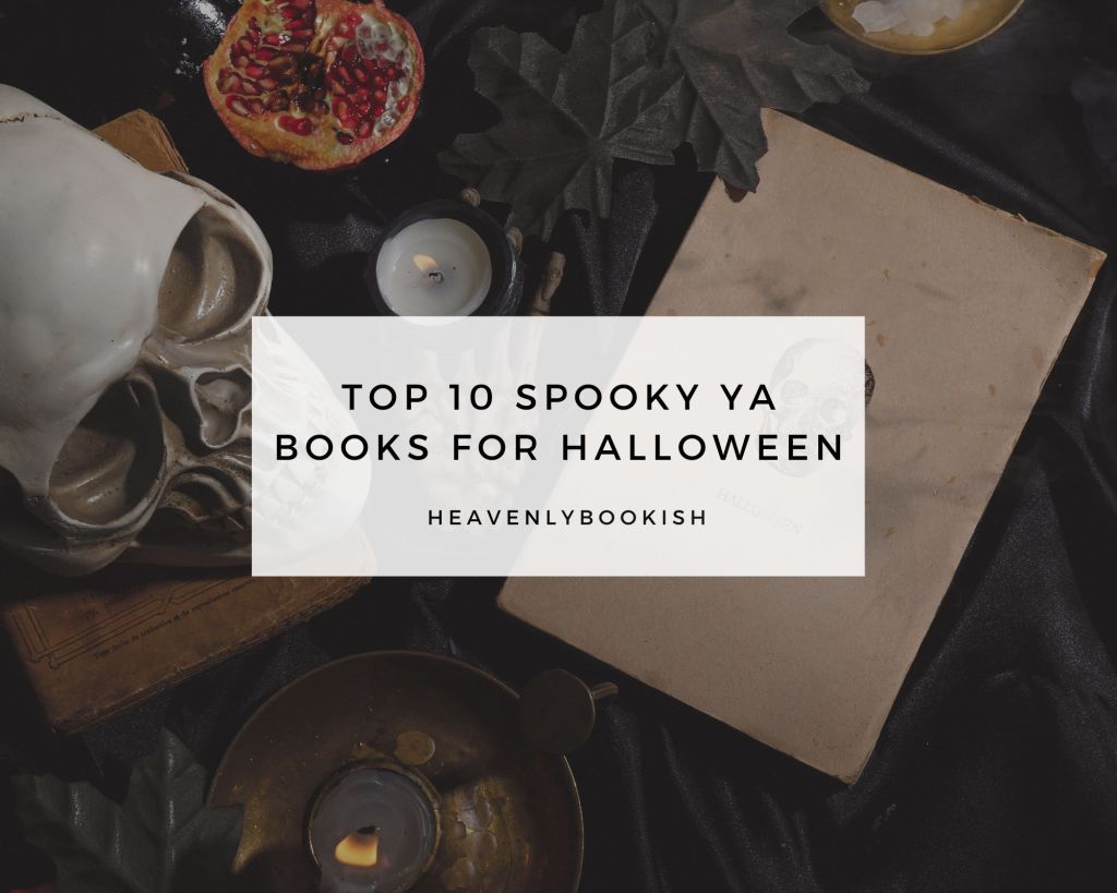 The image shows a dark, moody flatlay with a skull, a candle, a pomegranate, a brass dish, and some old books, all arranged to evoke a spooky, Halloween vibe. The centerpiece is a white box overlay with the text "Top 10 Spooky YA Books for Halloween" in bold font and "heavenlybookish" in smaller text underneath. The overall aesthetic feels eerie yet bookish, fitting for a Halloween-themed book list.